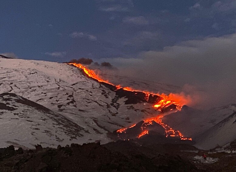 A snow-covered mountain with flowing lava. 4