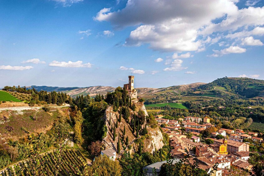 A town nestled in a valley with a prominent tower on a hill. 5
