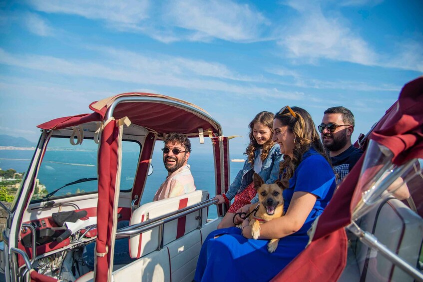 A group of people on a boat with a scenic view of the water and land. 3