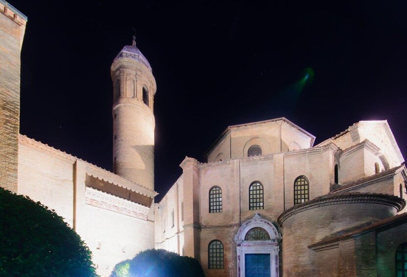 A historic building with a prominent tower and arched windows. 5