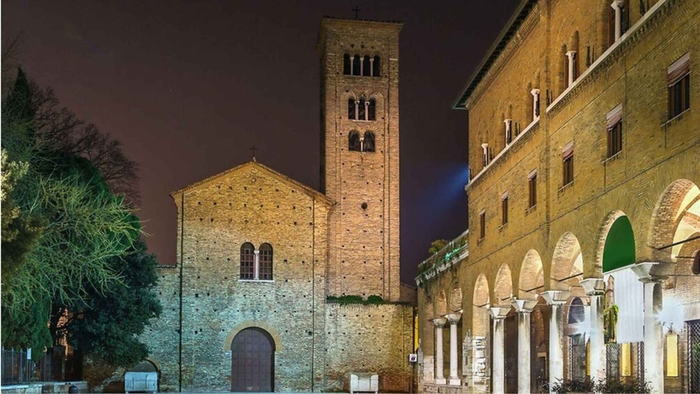 A historic building with a prominent tower and arched windows. 1