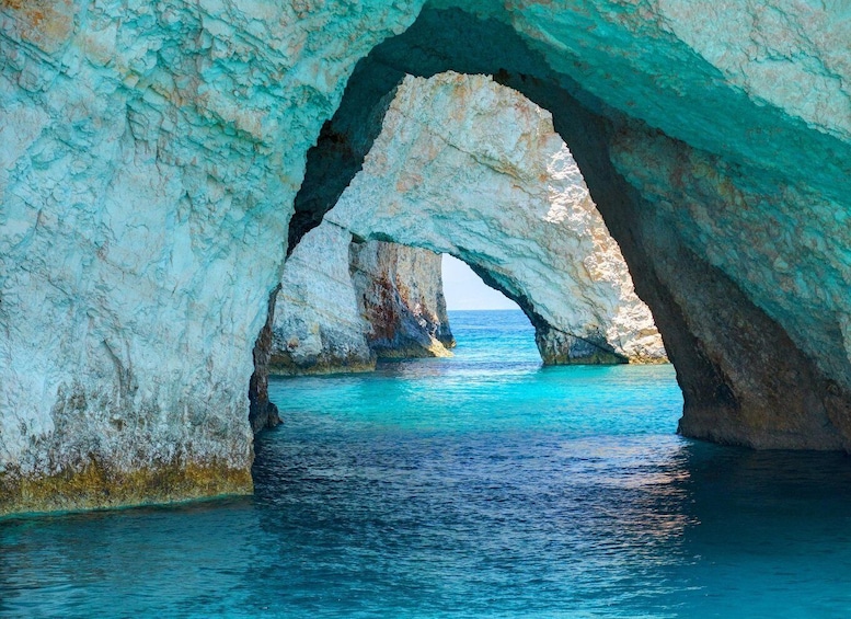 A natural rock arch formation over turquoise sea. 1