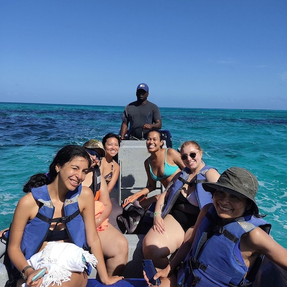 A group of people on a boat with the ocean in the background. 4