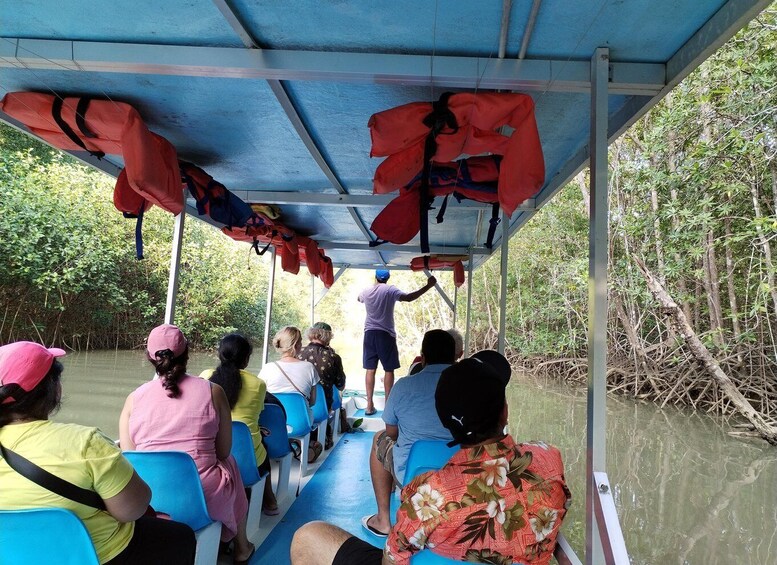 People on a boat with life jackets hanging overhead. 2