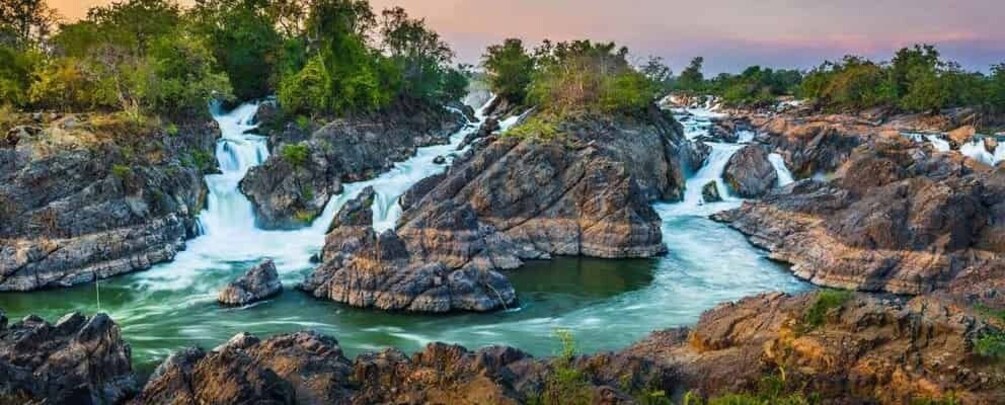 A river flowing through a rocky landscape with multiple waterfalls. 1