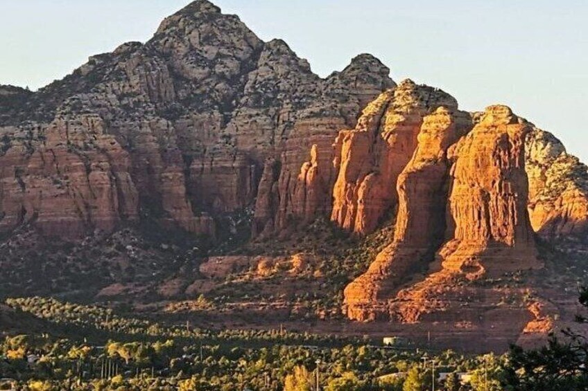 A mountain range with prominent rock formations and a valley below. 4