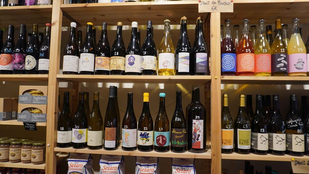 A variety of wine bottles on wooden shelves, each with a numbered label. 3