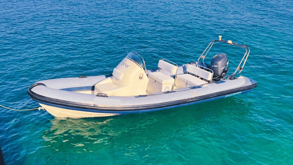 A small motorboat on clear turquoise water. 2