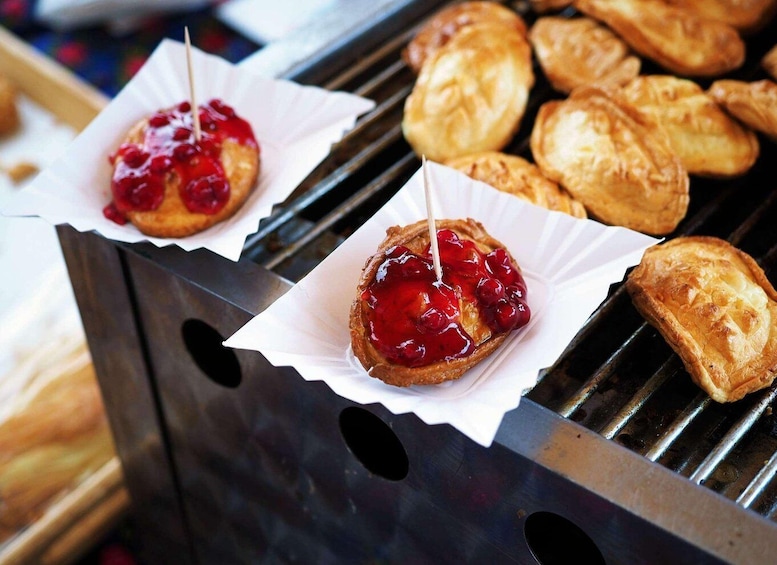Two pastries on a grill with a red topping. 4
