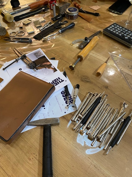 A workbench with tools, a notebook, and a QR code. 1