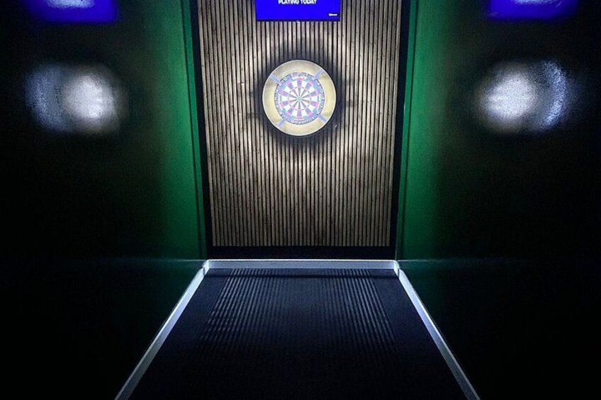 An elevator with a dartboard and a sign that reads 'TOURING TODAY.' 3