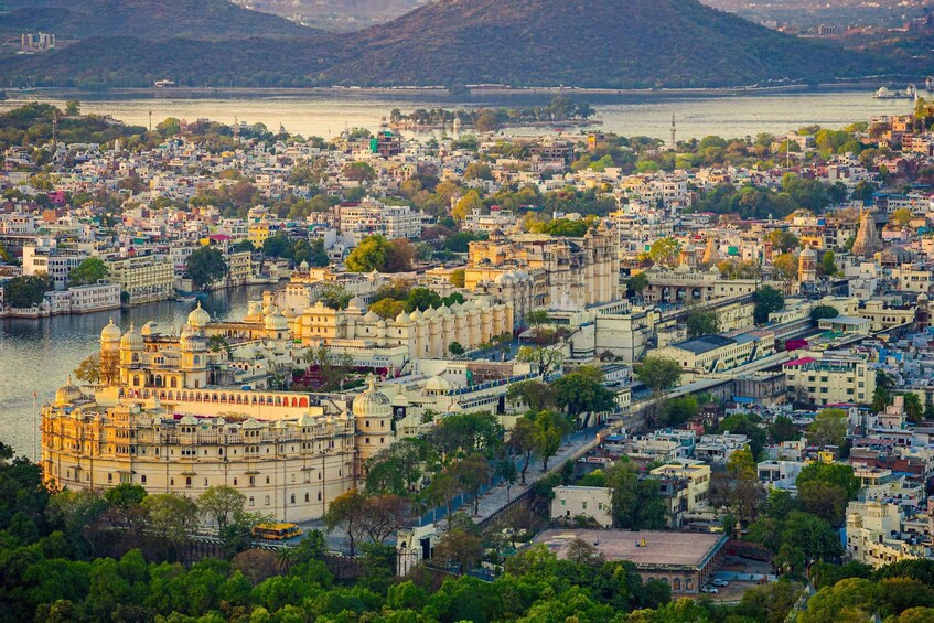 A cityscape with a prominent palace by a river, surrounded by dense urban areas and hills in the background. 5