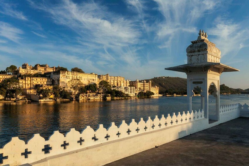A riverside view of a historic fort with a white pavilion. 3