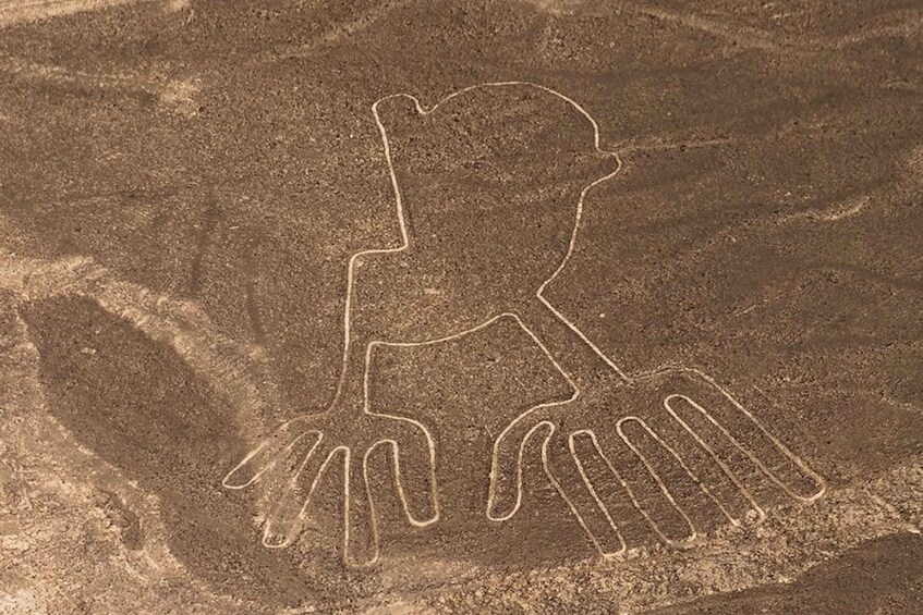 A prehistoric cave painting of a human figure with a bird. 4