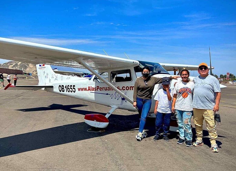 A small white airplane with the registration OB1655 parked on a tarmac. 5
