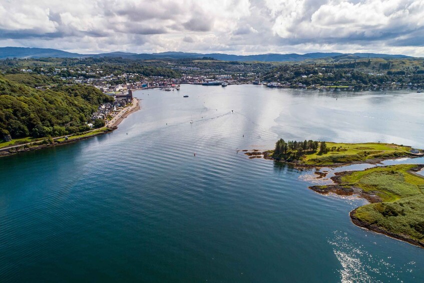 A large lake with a town on the left, surrounded by hills. 2
