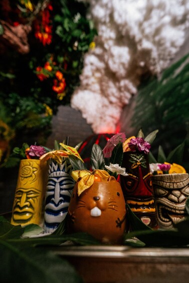 A collection of colorful, intricately decorated ceramic figures and masks, likely part of a cultural or religious display. 2