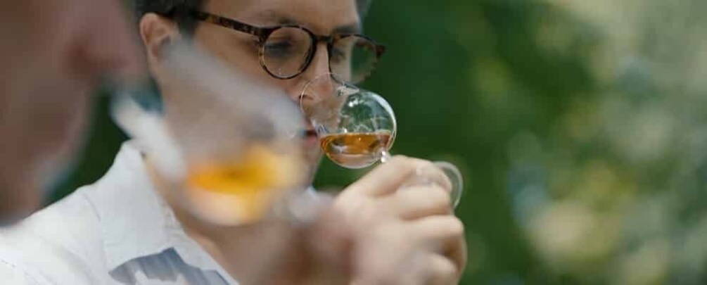 A person holding a wine glass. 4