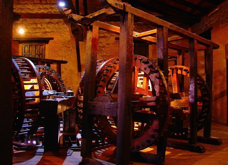 Large wooden water wheels in a rustic interior. 5