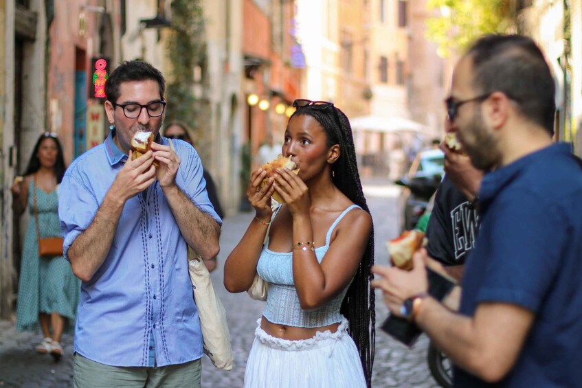 People eating on a cobblestone street. 5