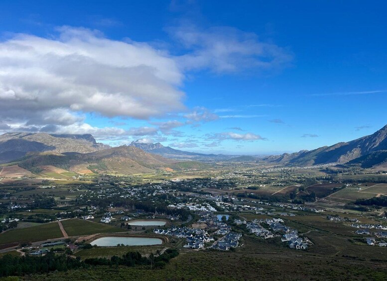 A town nestled in a valley with mountains in the background and a clear sky. 2