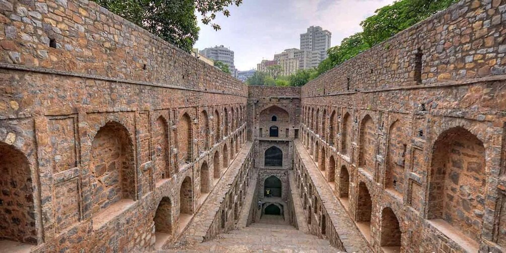 A stone fortress with arched walkways and a central entrance. 3