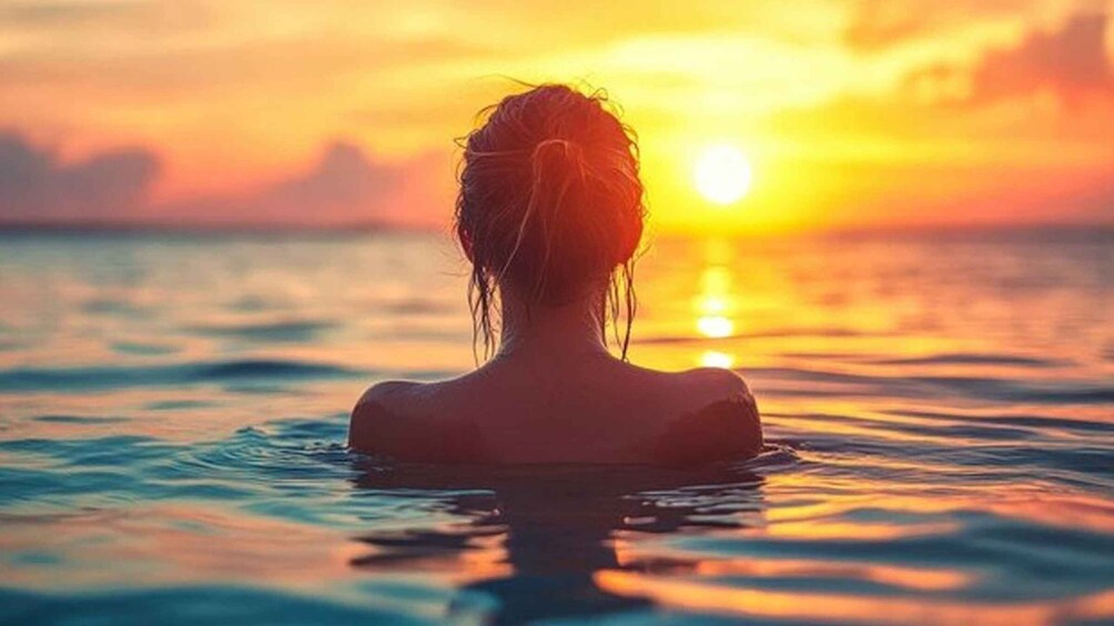 A person in water at sunset. 4