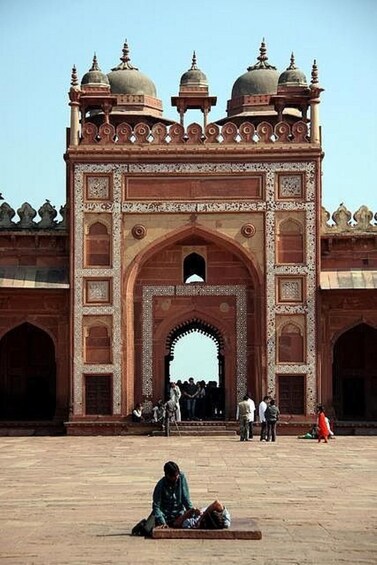 A large, ornate gateway with domed towers, a central archway, and intricate patterns. 4