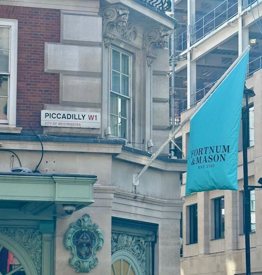 A building with a sign reading 'PICCADILLY W1' and a flag for 'FORTNUM & MASON EST 1707'. 4