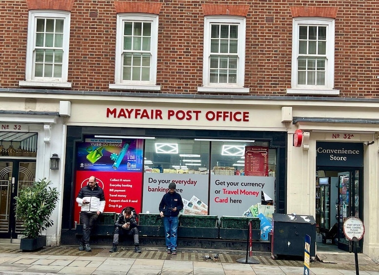 A Mayfair Post Office with a sign advertising new and improved services. 3