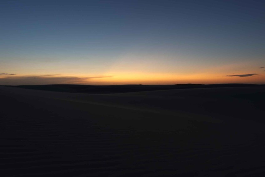A desert landscape at sunset with a clear sky. 3