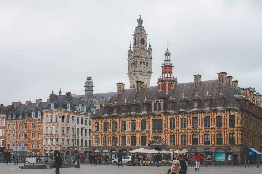 A historic square with ornate buildings and a prominent clock tower. 3