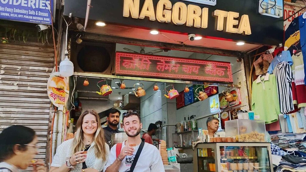 A tea shop named Nagori Tea with a red digital signboard and hanging teapots. 5