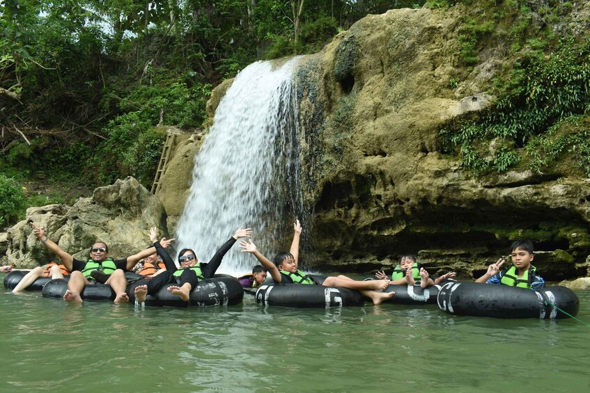 People rafting on tubes near a waterfall. 4