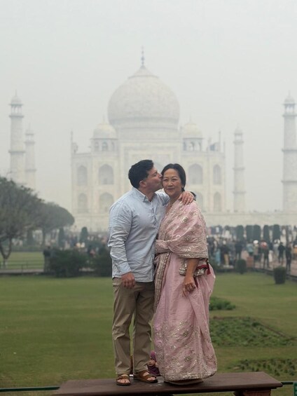A couple standing in front of the Taj Mahal. 3