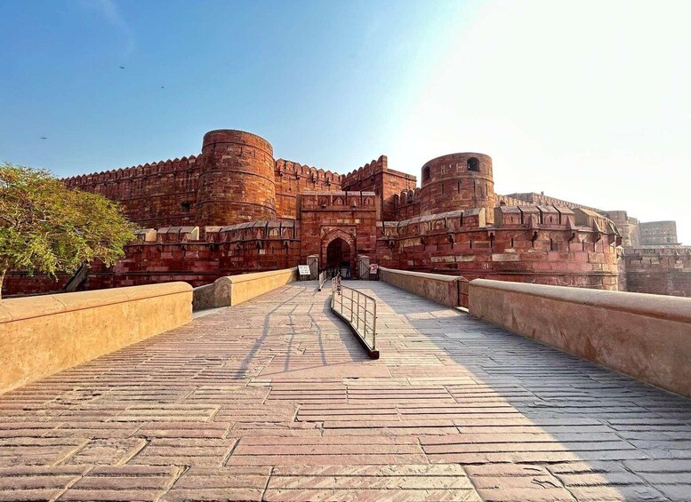 A historical fort with red brick walls and a central gateway. 4