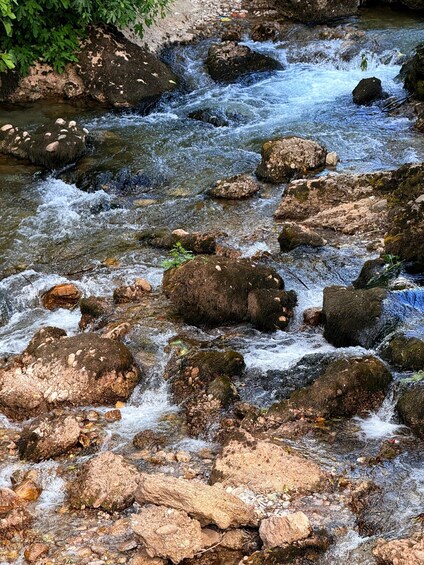 A flowing stream with rocks and pebbles. 2