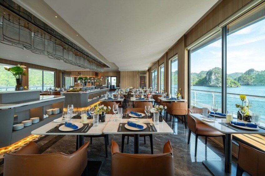 A modern restaurant with large windows overlooking a body of water. 5