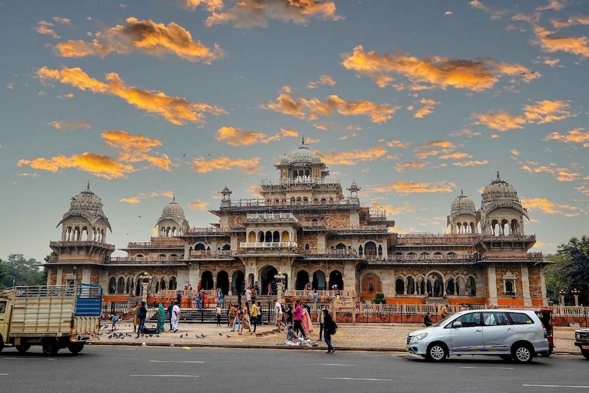 A historic building with multiple domes and arches, surrounded by a busy street with pedestrians and vehicles. 4