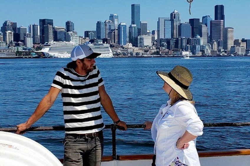 A man and a woman on a boat with a city skyline in the background. 5