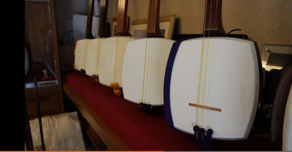 A row of white lamps with blue bases and yellow cords on a wooden table. 2