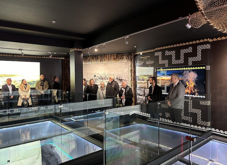 A museum exhibit with glass display cases and informational posters. 2