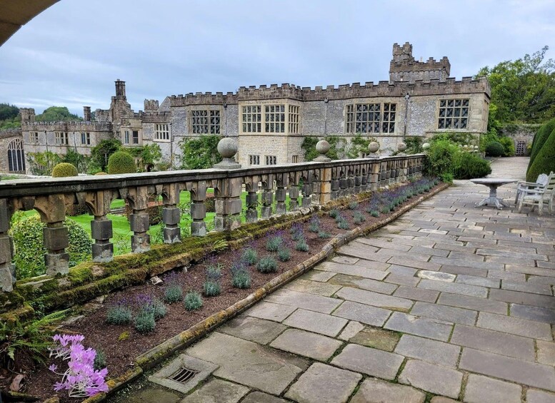 A stone pathway leading to a historic building with a castle-like structure. 5