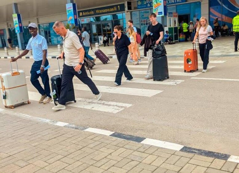A busy airport terminal with people walking with luggage. 5