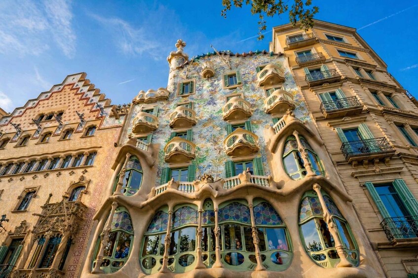 A building with unique architecture, featuring balconies, windows, and decorative elements. 4
