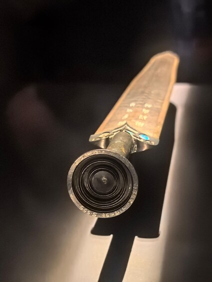 A vintage camera with a lens and a bellows mechanism. 1