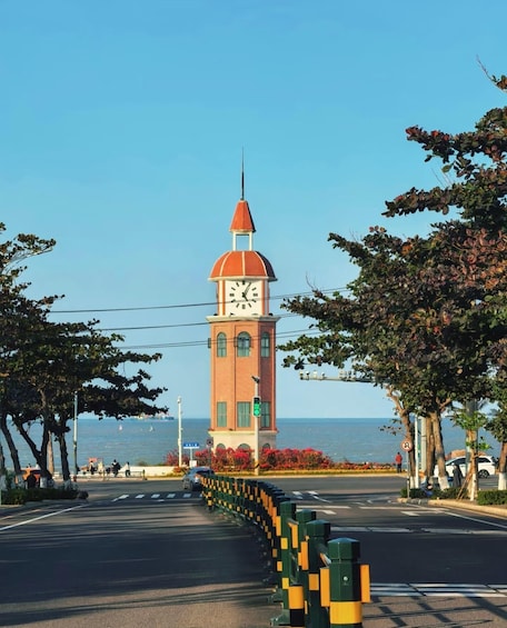 A clock tower by the sea with a clear sky. 1