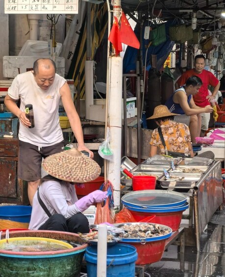 A market stall with seafood displayed in large containers. 5