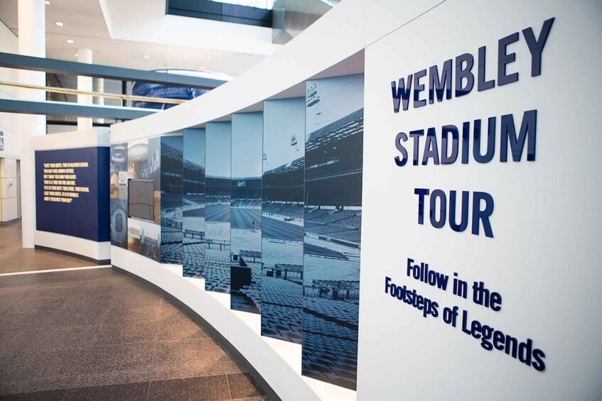 A wall with the text 'WEMBLEY STADIUM TOUR' and 'Follow in the footsteps of legends.' 4