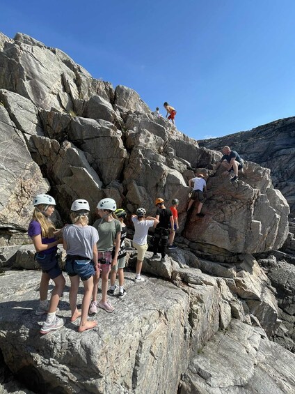 A group of people climbing a rocky mountain. 5